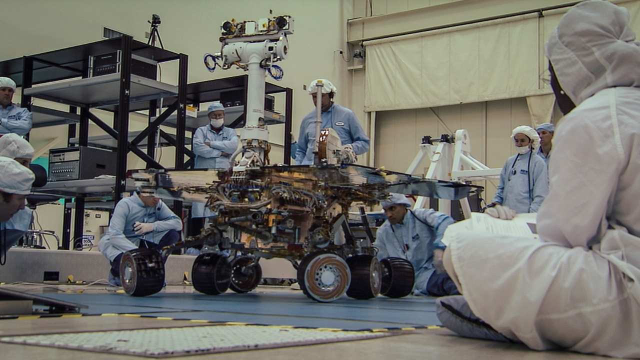 a group of engineers working on a machine